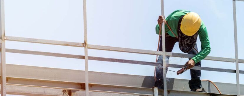 In the construction site, the welding workers at work., worker weld metal in factory and sparks
