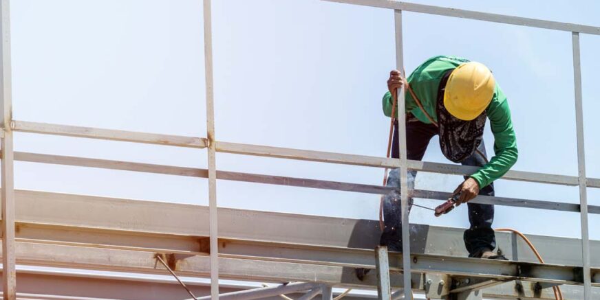 In the construction site, the welding workers at work., worker weld metal in factory and sparks